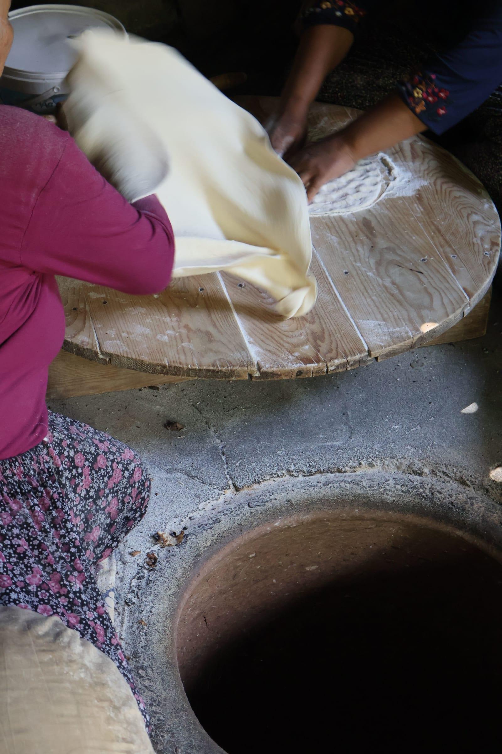 Stretching the dough thin by hand